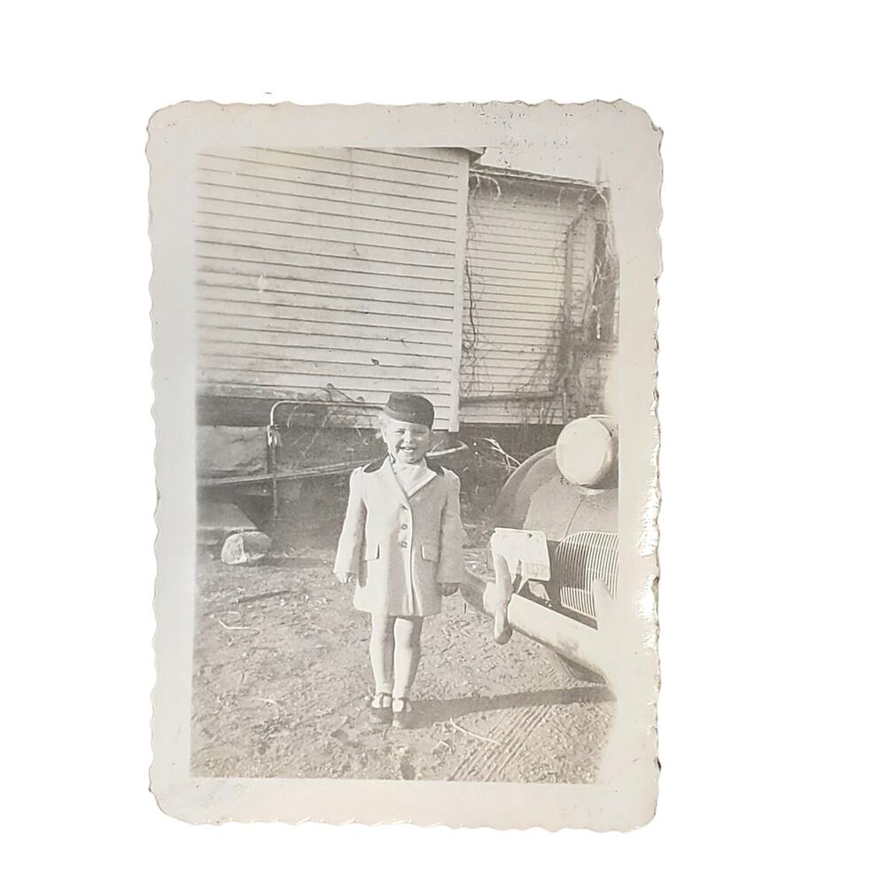 Vtg Child Posing Next to Vehicle Monochrome Photography Found Snapshot B&W